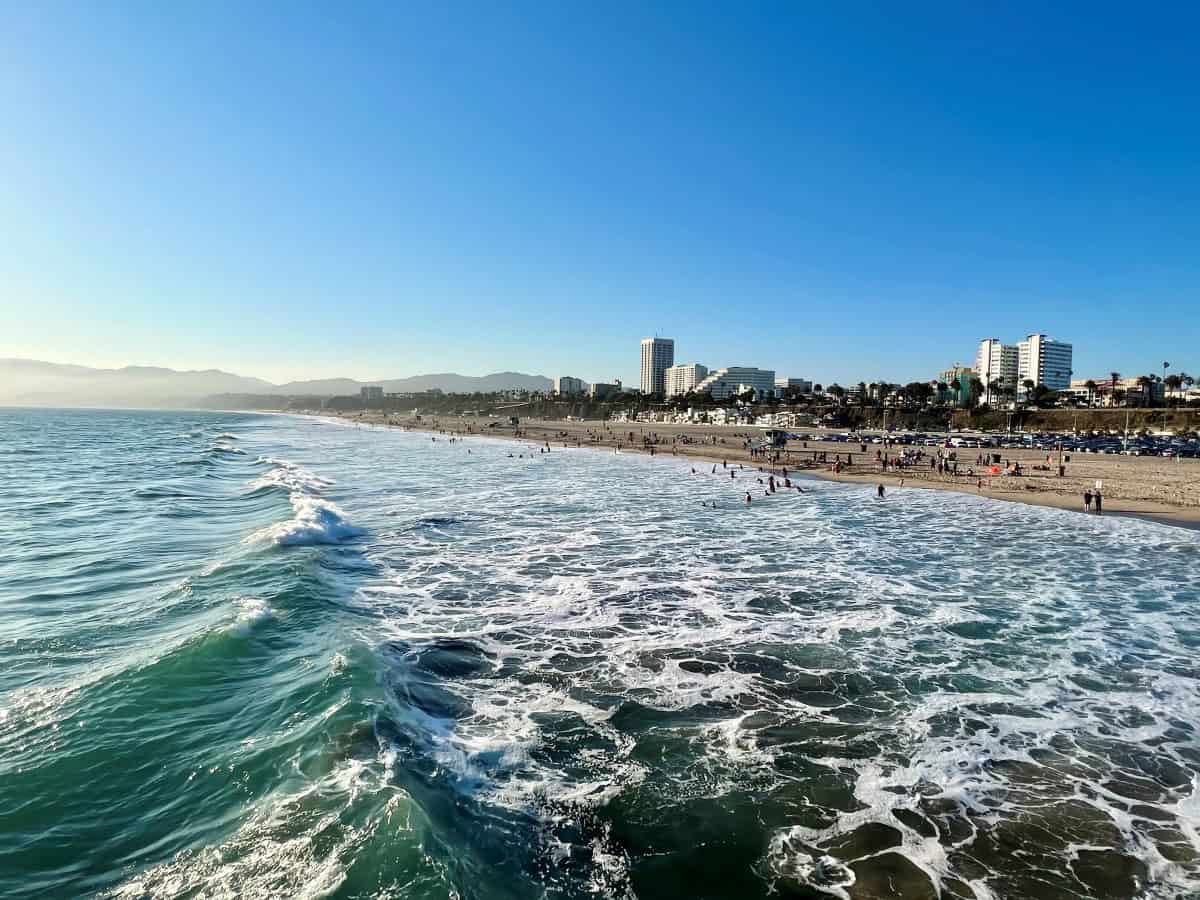 Waves in ocean with beach in the distance