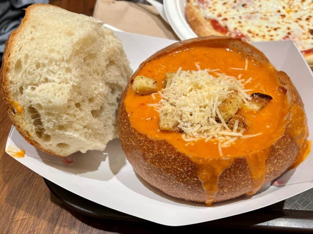 Creamy tomato soup in a sourdough bread bowl