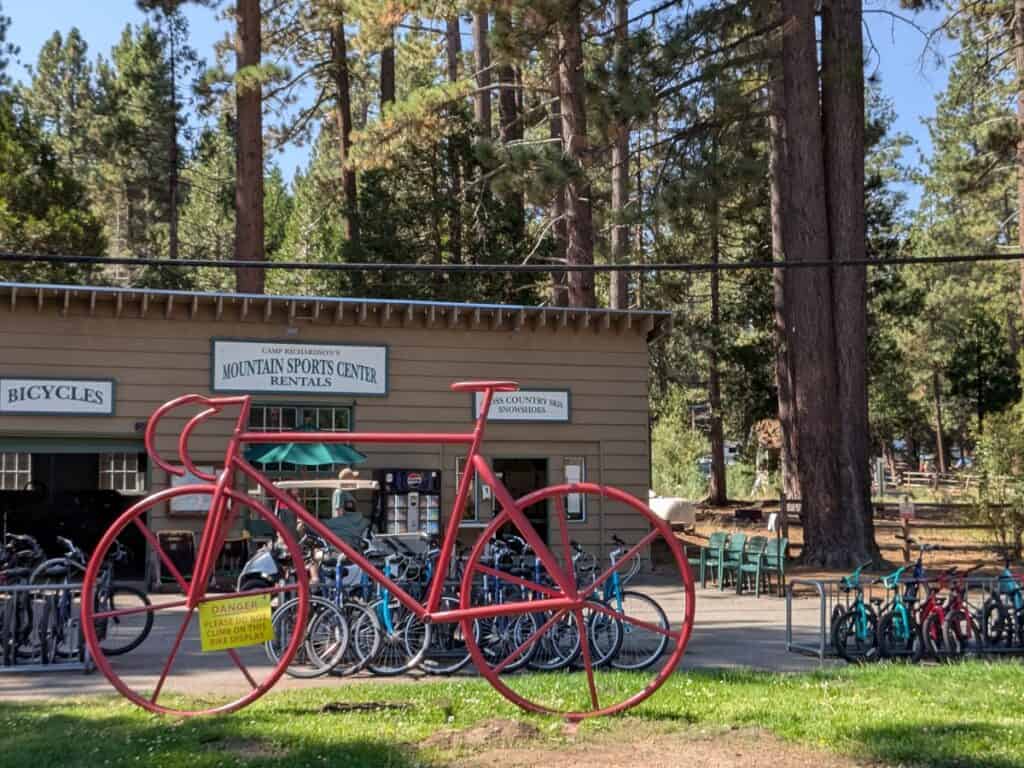 Bike rental shop with a large red metal bike for display in the front