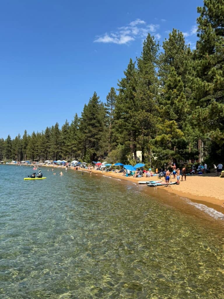 A lakeside beach with clear water