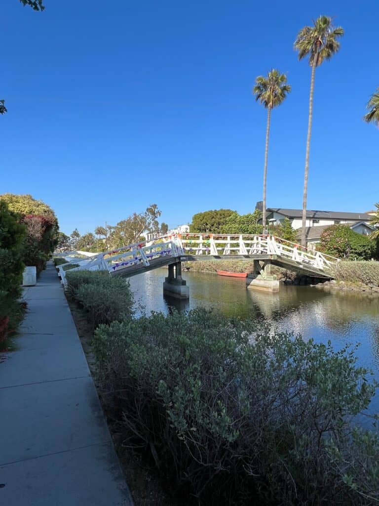 a white bridge over a canal