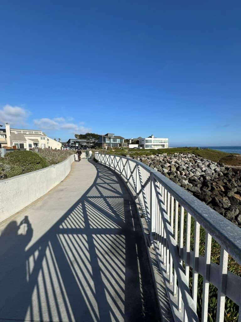 a paved walking path along the ocean bluffs
