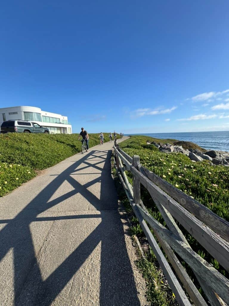 a paved walking path along the ocean bluffs
