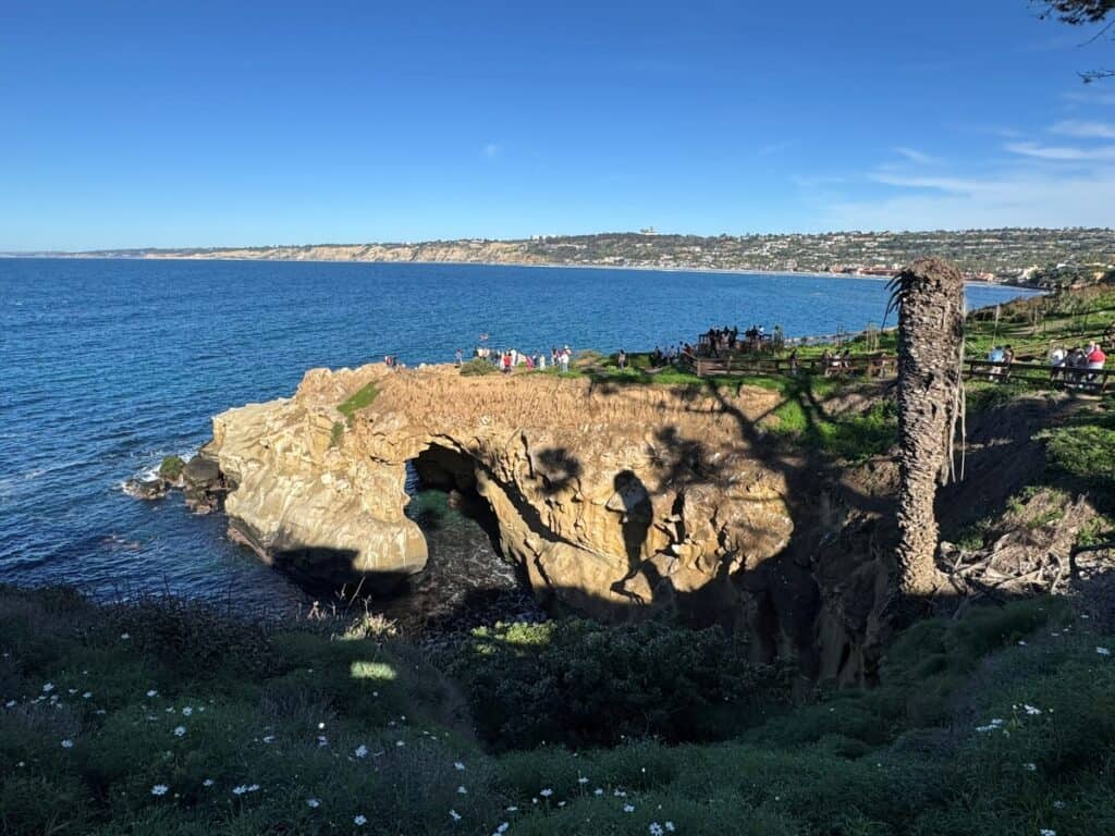 Rocky cliff with a cave and an overlook at La Jolla Cove